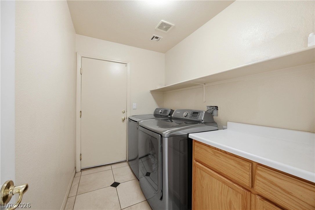 6109 Ocho Rios Street Las Vegas, NV 89130 - Photo 19 of 36 Laundry area featuring washing machine and dryer and light tile patterned flooring