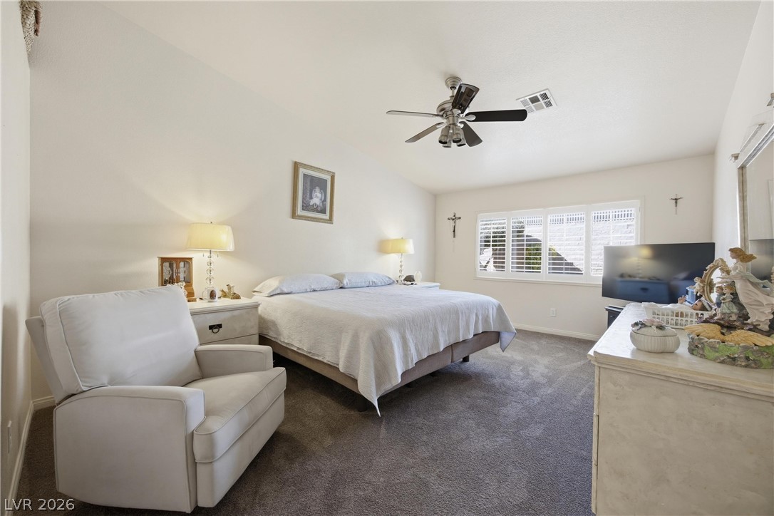6109 Ocho Rios Street Las Vegas, NV 89130 - Photo 20 of 36 Bedroom featuring dark colored carpet, a ceiling fan, and lofted ceiling