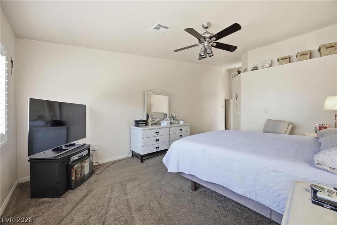 6109 Ocho Rios Street Las Vegas, NV 89130 - Photo 22 of 36 Bedroom featuring dark carpet and a ceiling fan
