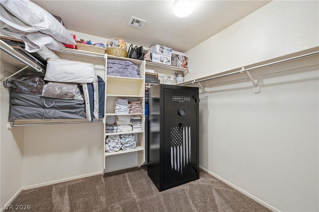 6109 Ocho Rios Street Las Vegas, NV 89130 - Photo 23 of 36 Walk in closet featuring dark carpet