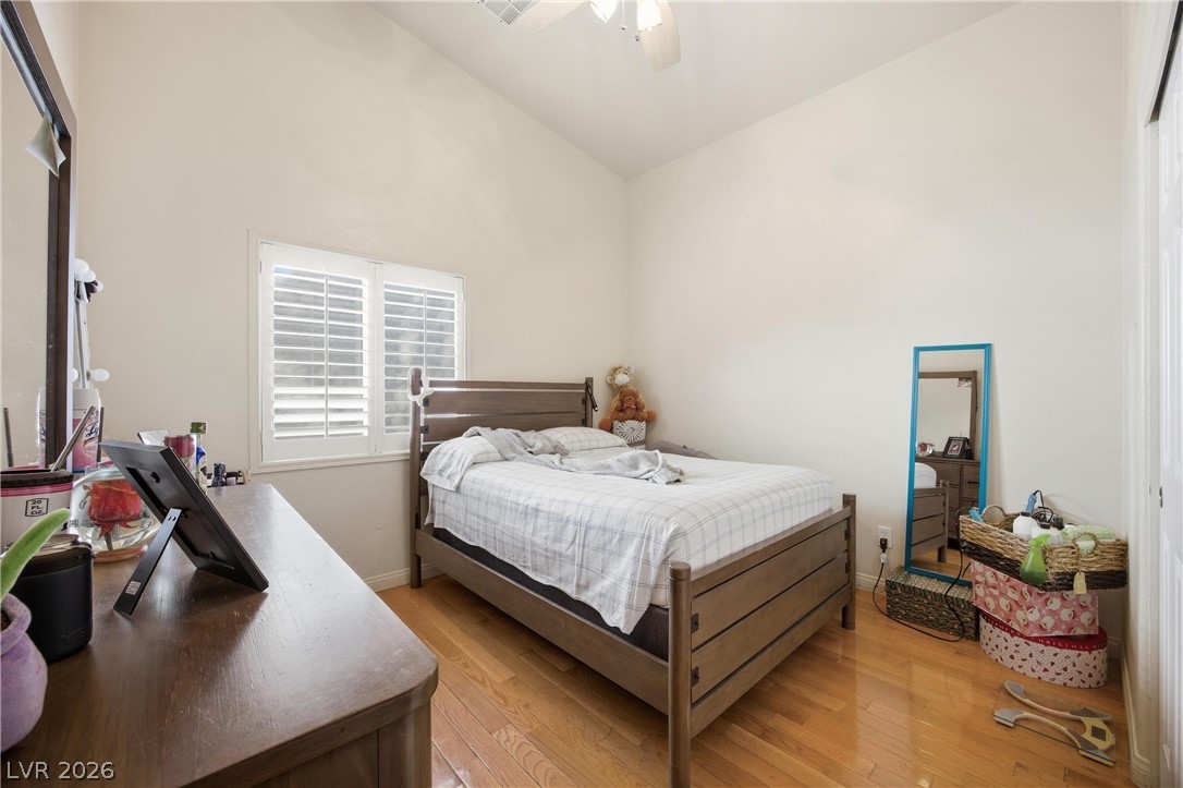 6109 Ocho Rios Street Las Vegas, NV 89130 - Photo 24 of 36 Bedroom featuring light wood-style flooring, vaulted ceiling, and a ceiling fan