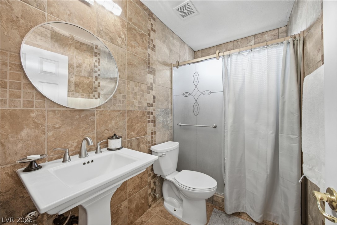 6109 Ocho Rios Street Las Vegas, NV 89130 - Photo 25 of 36 Bathroom with tile walls and a shower stall