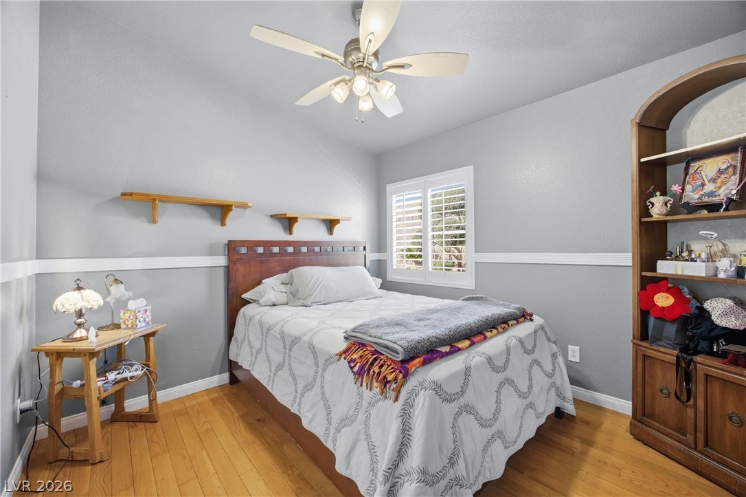 6109 Ocho Rios Street Las Vegas, NV 89130 - Photo 26 of 36 Bedroom featuring light wood-type flooring, lofted ceiling, and a ceiling fan