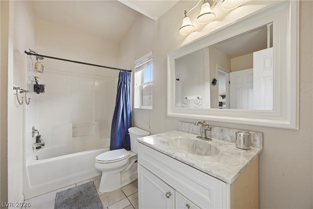 6109 Ocho Rios Street Las Vegas, NV 89130 - Photo 27 of 36 Full bathroom featuring vanity, shower / tub combo with curtain, and light tile patterned floors