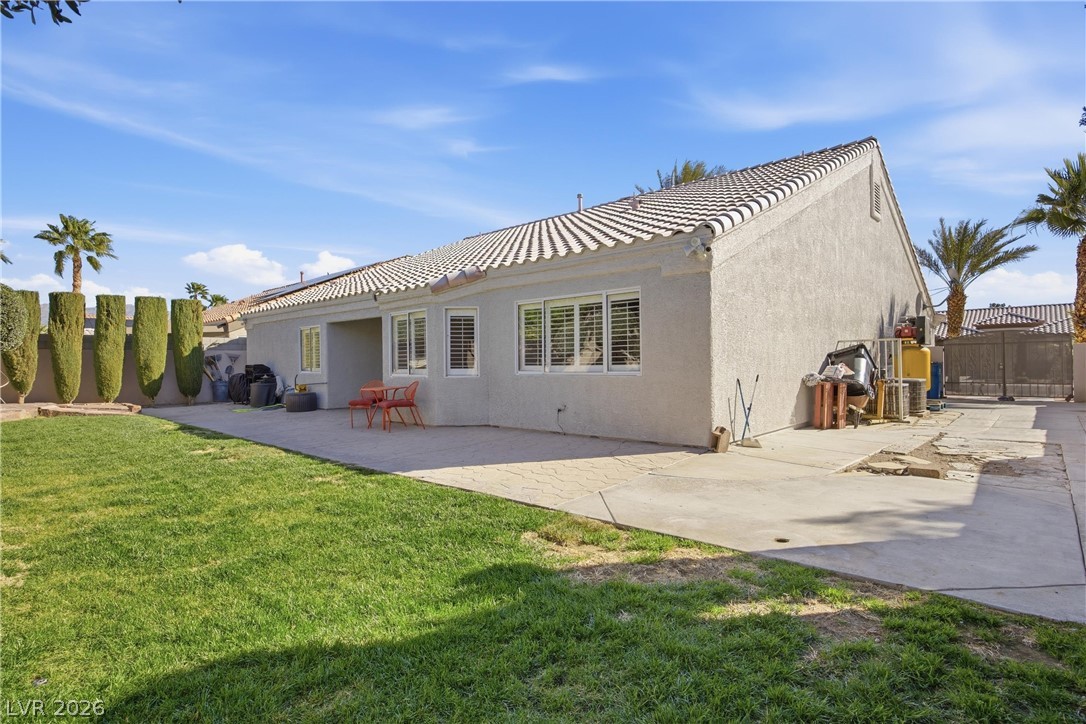 6109 Ocho Rios Street Las Vegas, NV 89130 - Photo 7 of 36 Back of house with stucco siding, a patio, a gate, and a tiled roof
