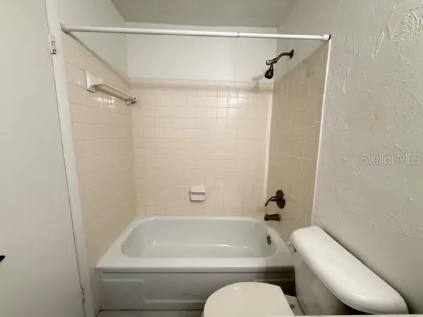 a bathroom with a toilet and a bathtub