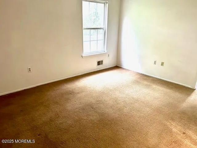 an empty room with a windows