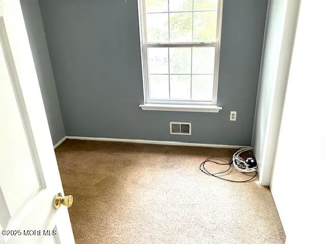 a view of a room with window and furniture