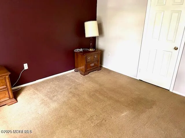 a bedroom with a bed and a lamp on table