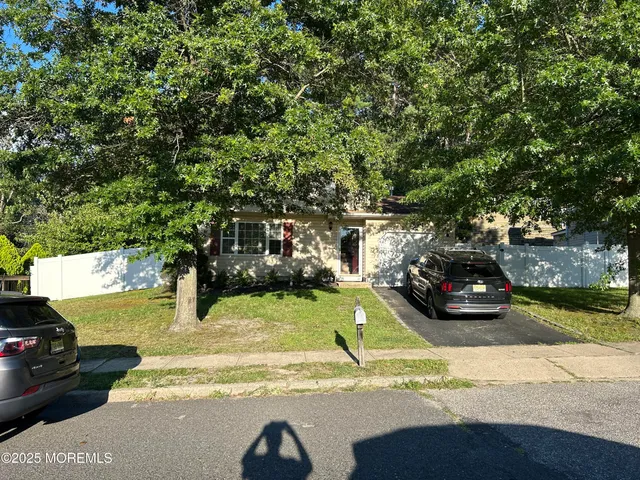 a view of a yard with yellow house