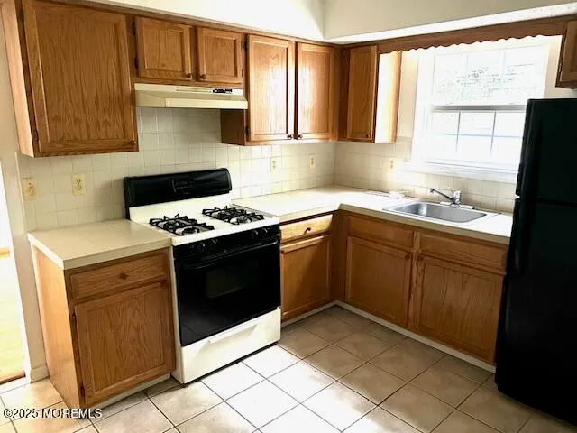 a kitchen with cabinets appliances and a window