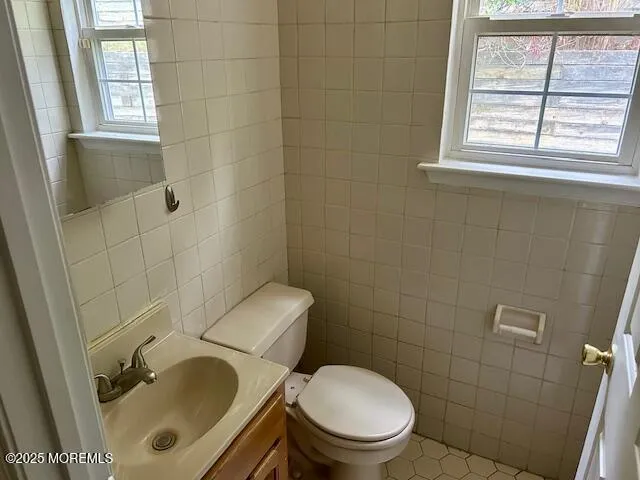 a white toilet sitting next to a bathroom sink