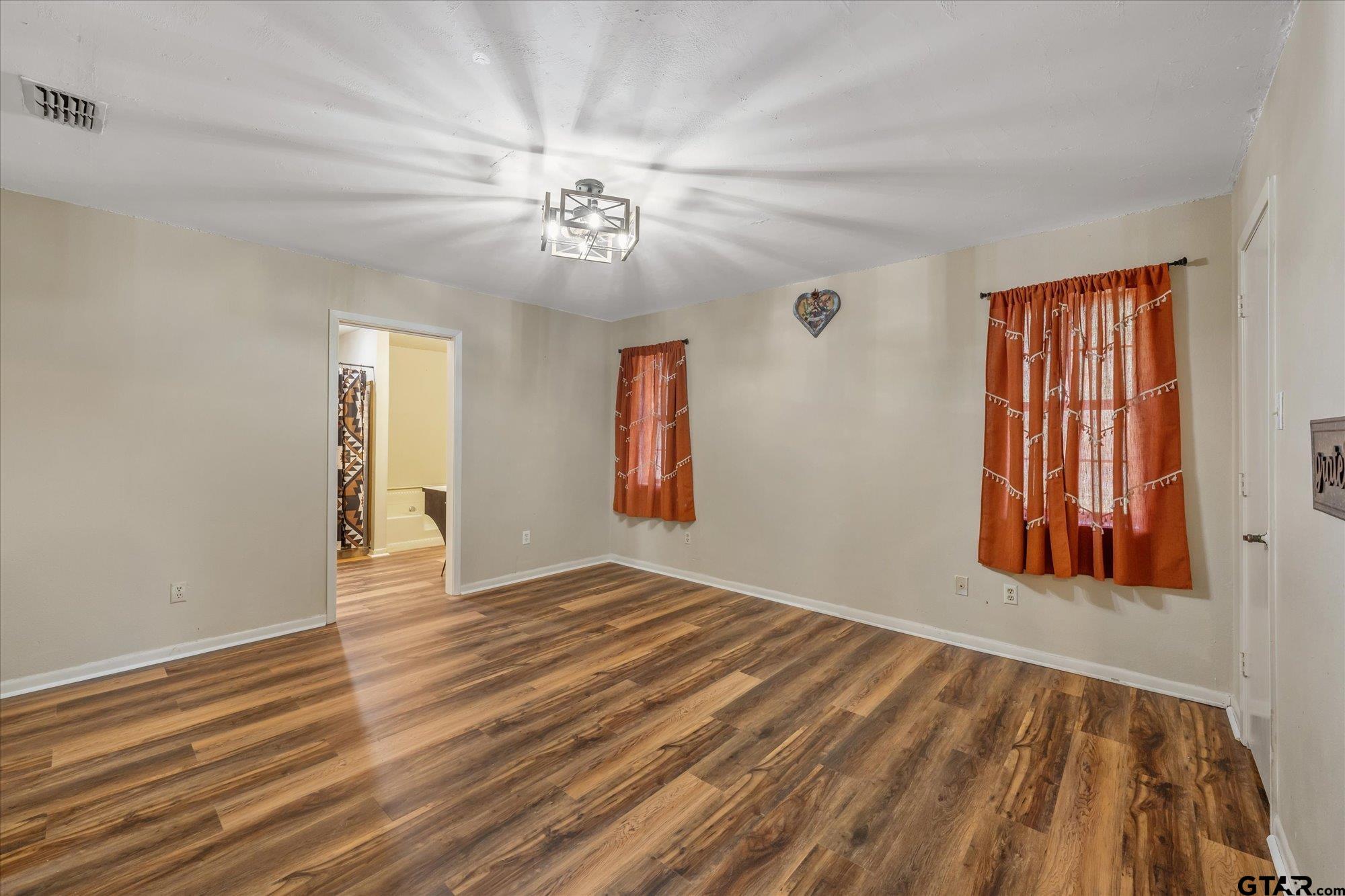 226 Colonial Circle Athens, TX 75751 - Photo 15 of 29 a view of an empty room with window and wooden floor