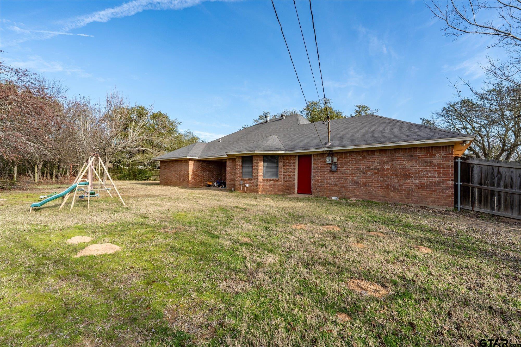 226 Colonial Circle Athens, TX 75751 - Photo 27 of 29 a backyard of a house with table and chairs