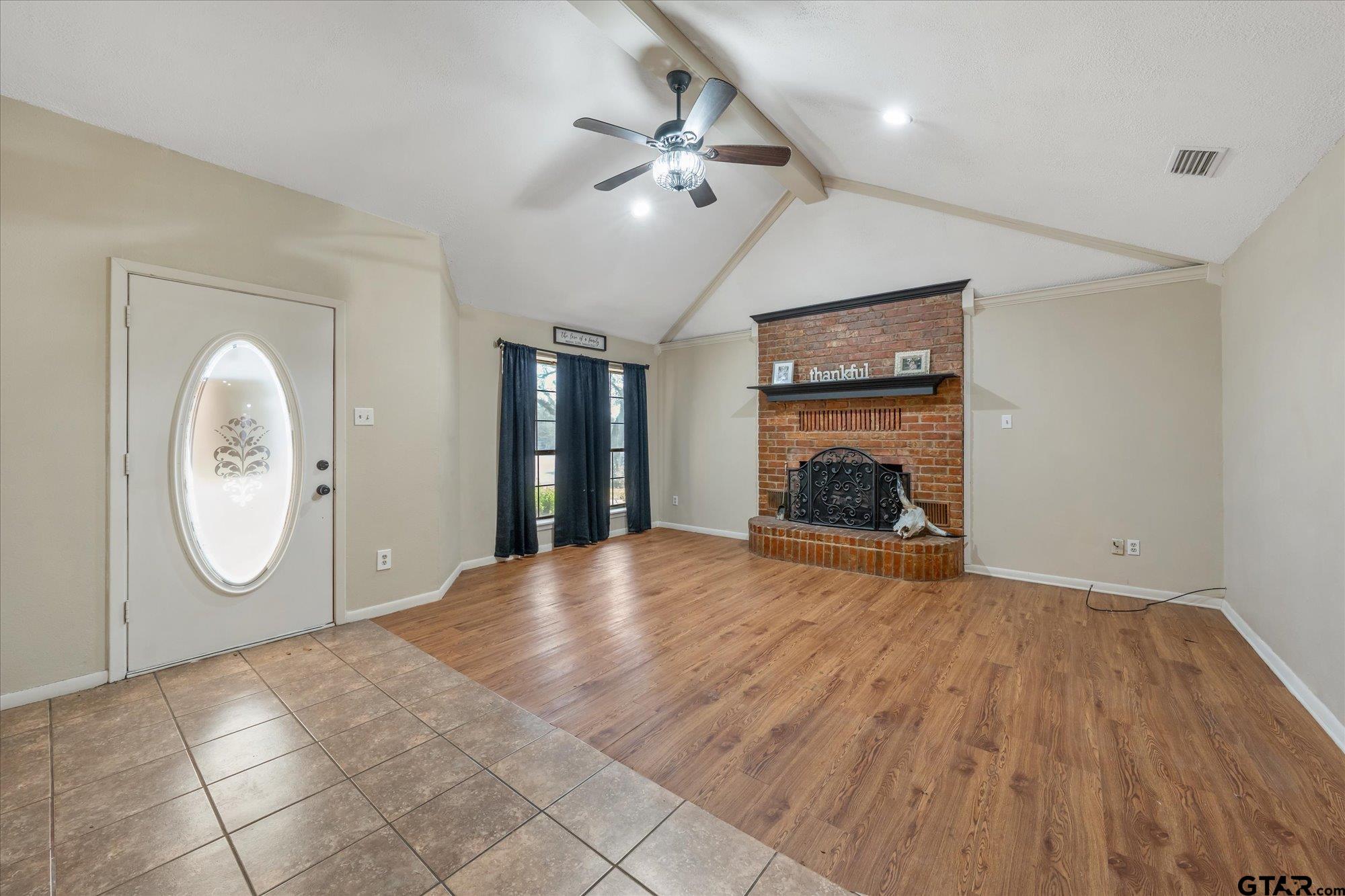 226 Colonial Circle Athens, TX 75751 - Photo 3 of 29 a view of an empty room with a fireplace and wooden floor
