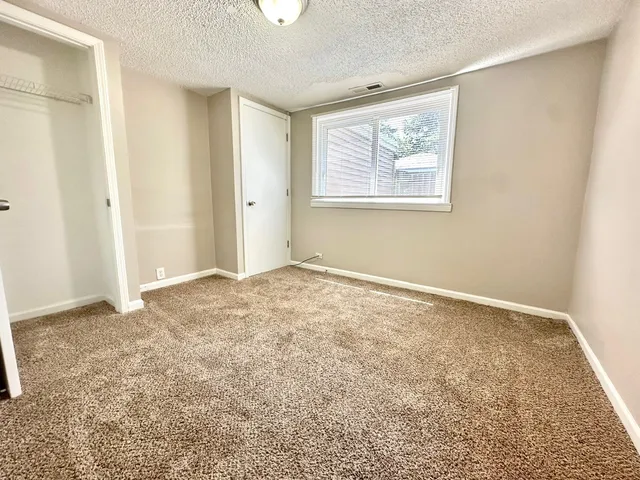 a kitchen with stainless steel appliances granite countertop a refrigerator a stove and a sink