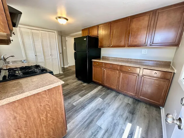 a view of a bathroom with a sink and wooden floor