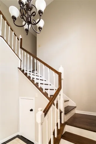 a view of staircase with wooden floor and fan
