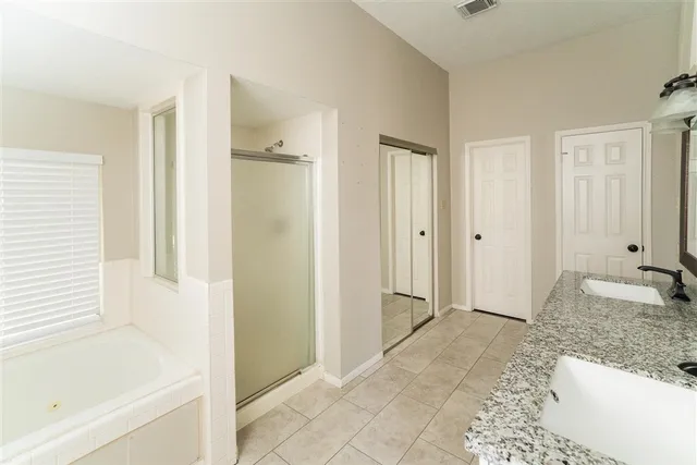a bathroom with a bathtub and a shower