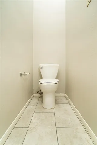 a view of a room with wooden floor a ceiling fan and a window