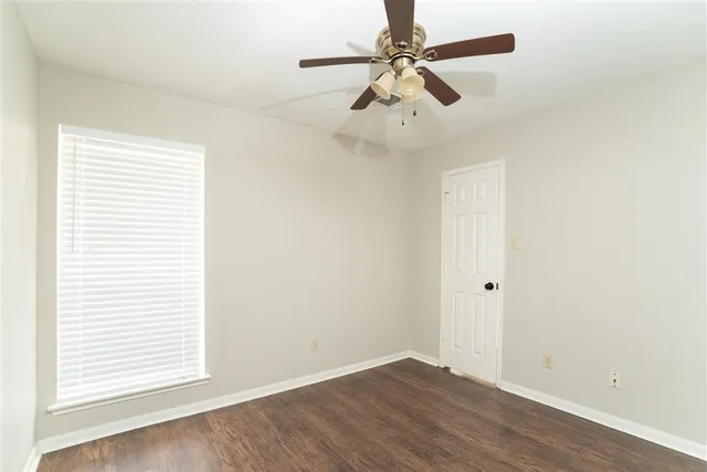 a view of staircase with wooden floor and white walls