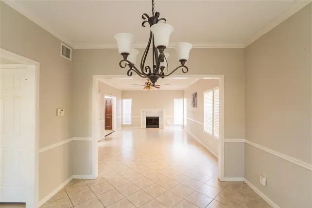 a view of a hallway with a chandelier and chandelier