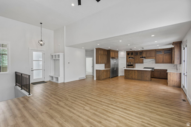 728 East Mountain Road North Ogden, UT 84414 - Photo 3 of 28 Expansive open-concept living area featuring wood-finish flooring and soaring ceilings
