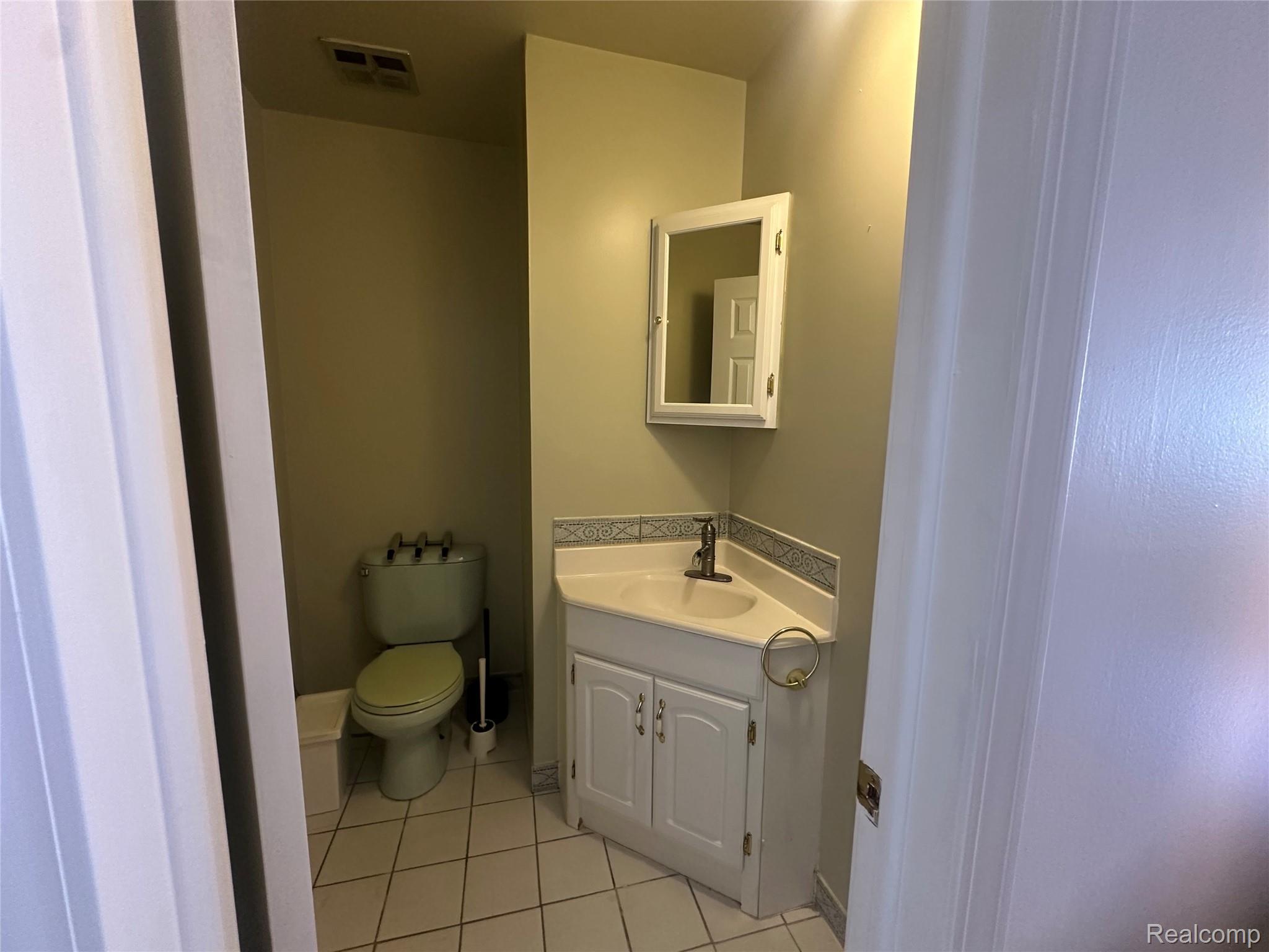 509 East University Drive Rochester, MI 48307 - Photo 16 of 20 Bathroom featuring light tile patterned floors and vanity