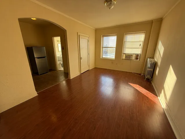 wooden floor in an empty room with a window