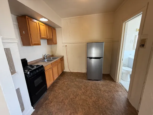 a kitchen with a refrigerator and a sink