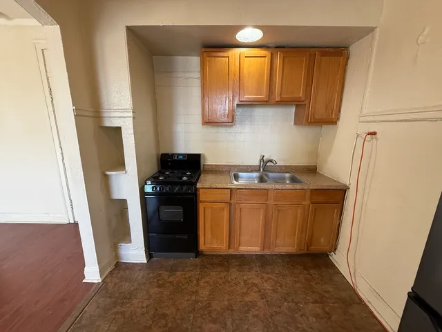 a kitchen with stainless steel appliances granite countertop a refrigerator and a sink