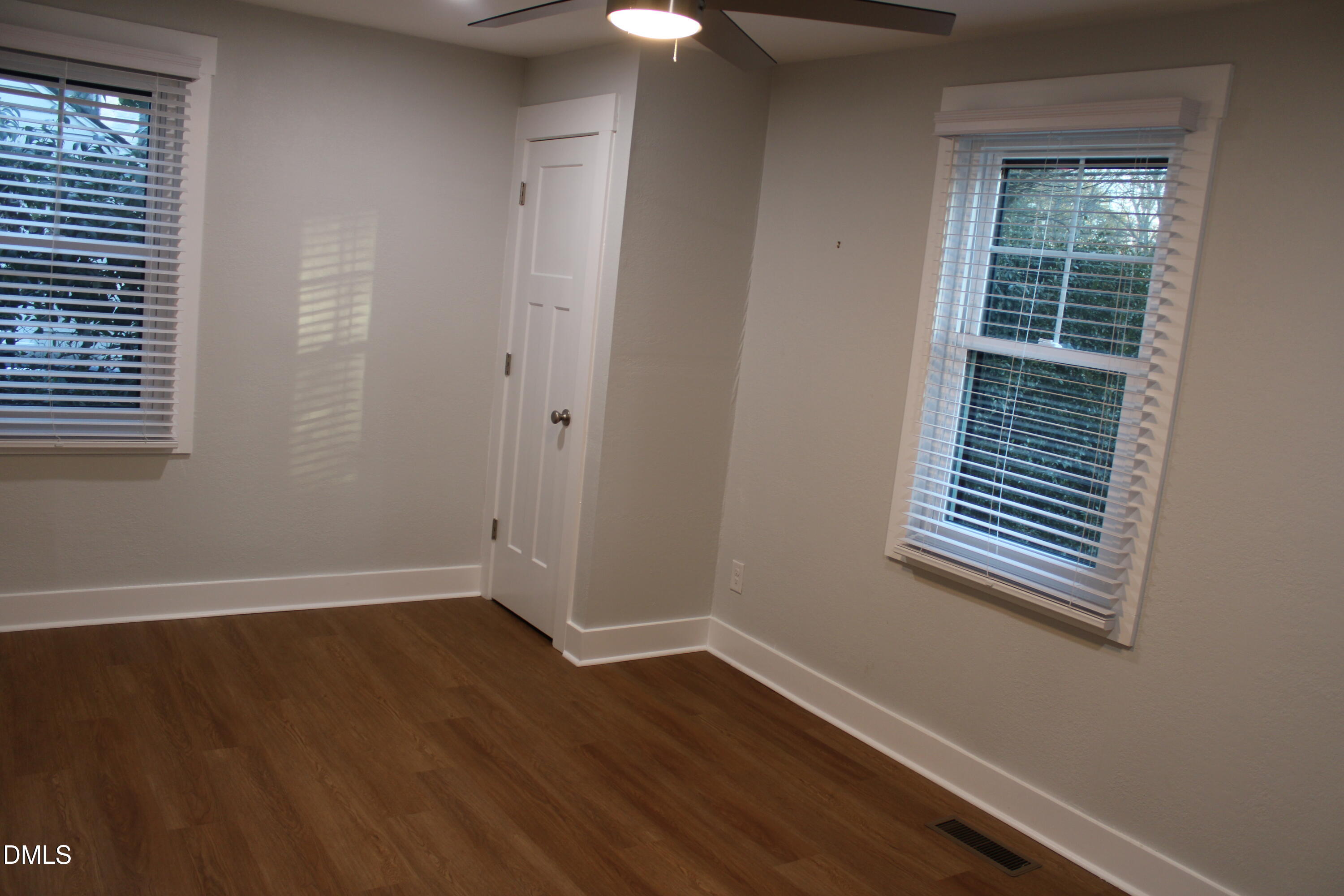 2812 Mayview Road Raleigh, NC 27607 - Photo 11 of 20 a view of an empty room with wooden floor and a window