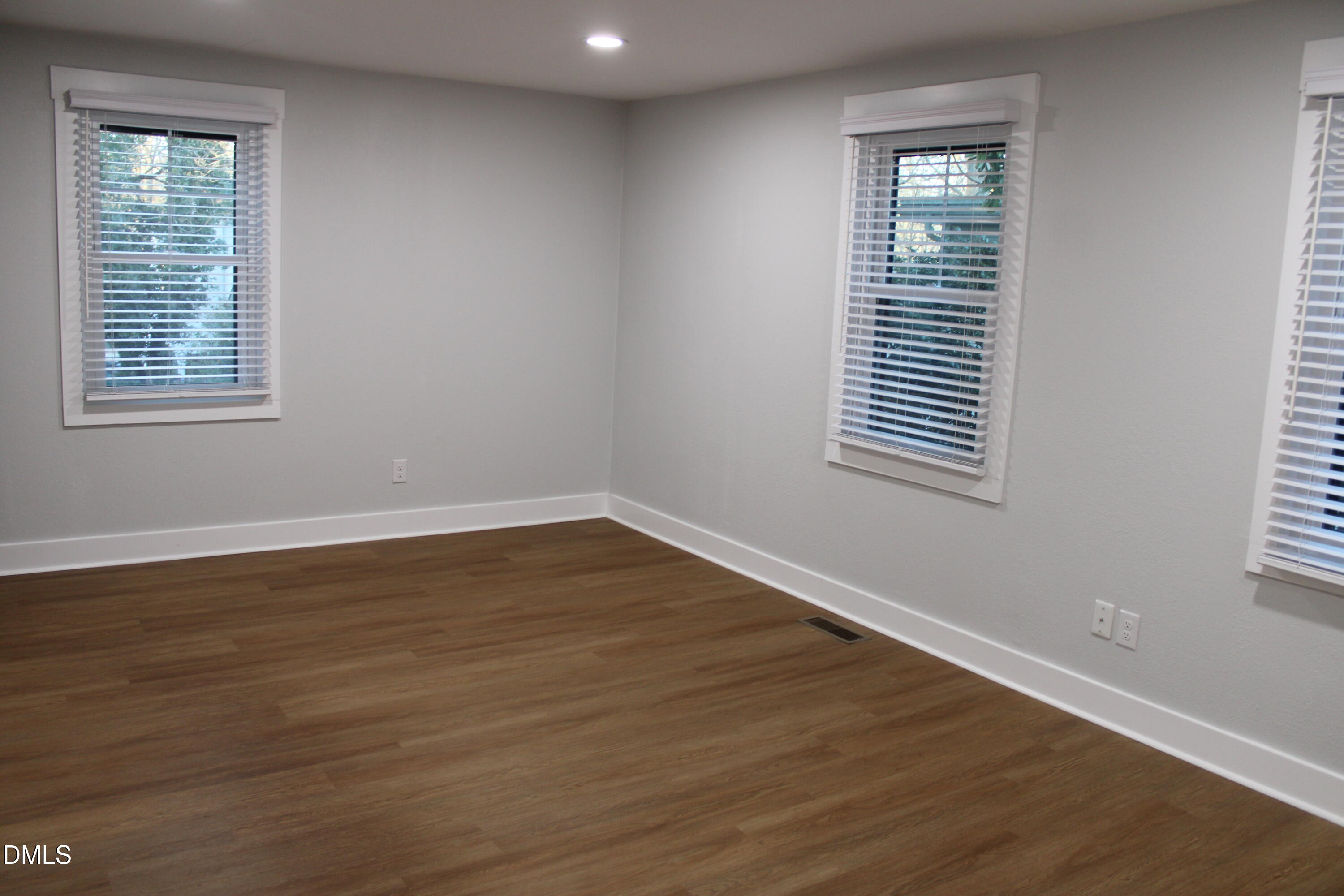 2812 Mayview Road Raleigh, NC 27607 - Photo 12 of 20 a view of an empty room with wooden floor and a window