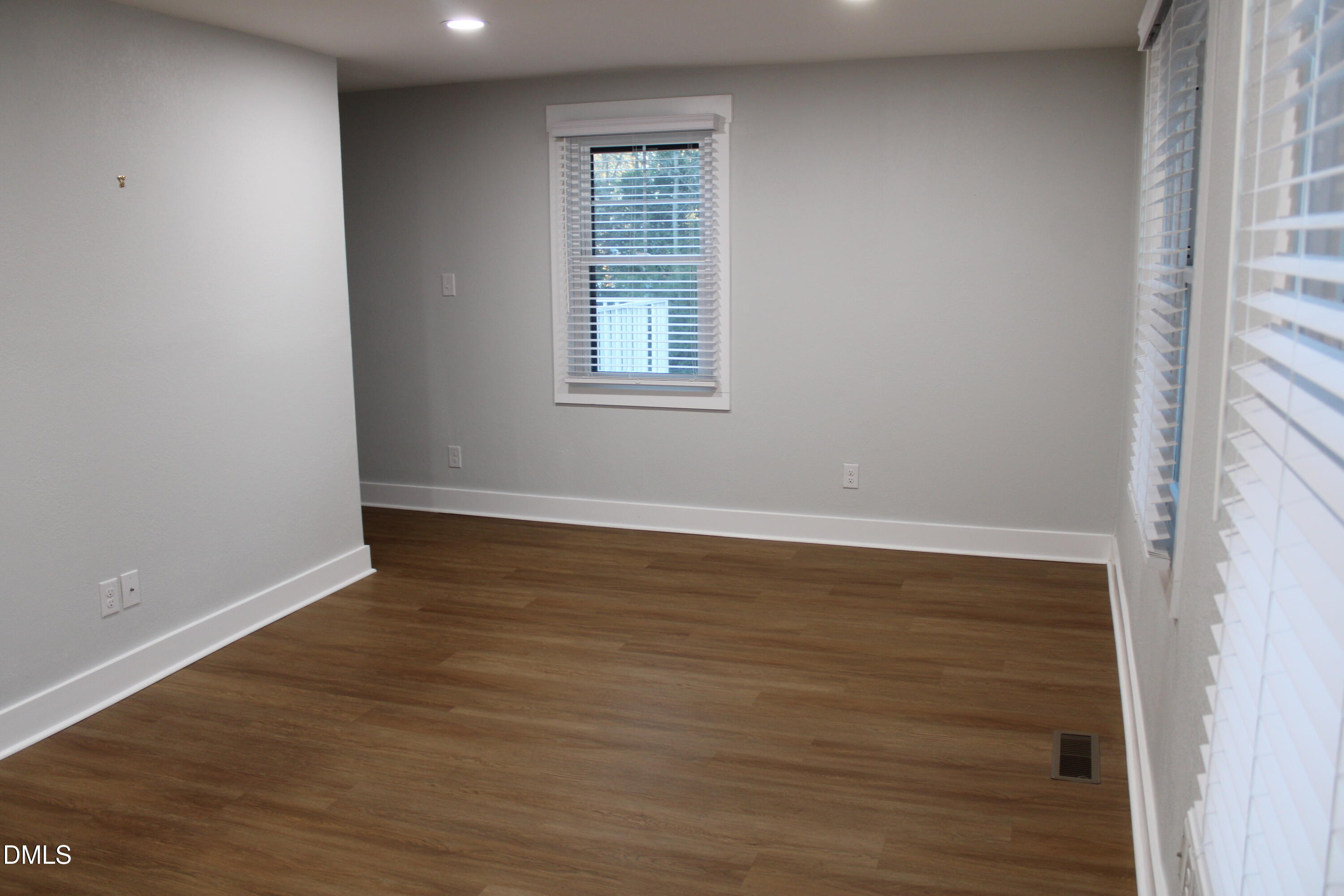 2812 Mayview Road Raleigh, NC 27607 - Photo 13 of 20 wooden floor in an empty room with a window