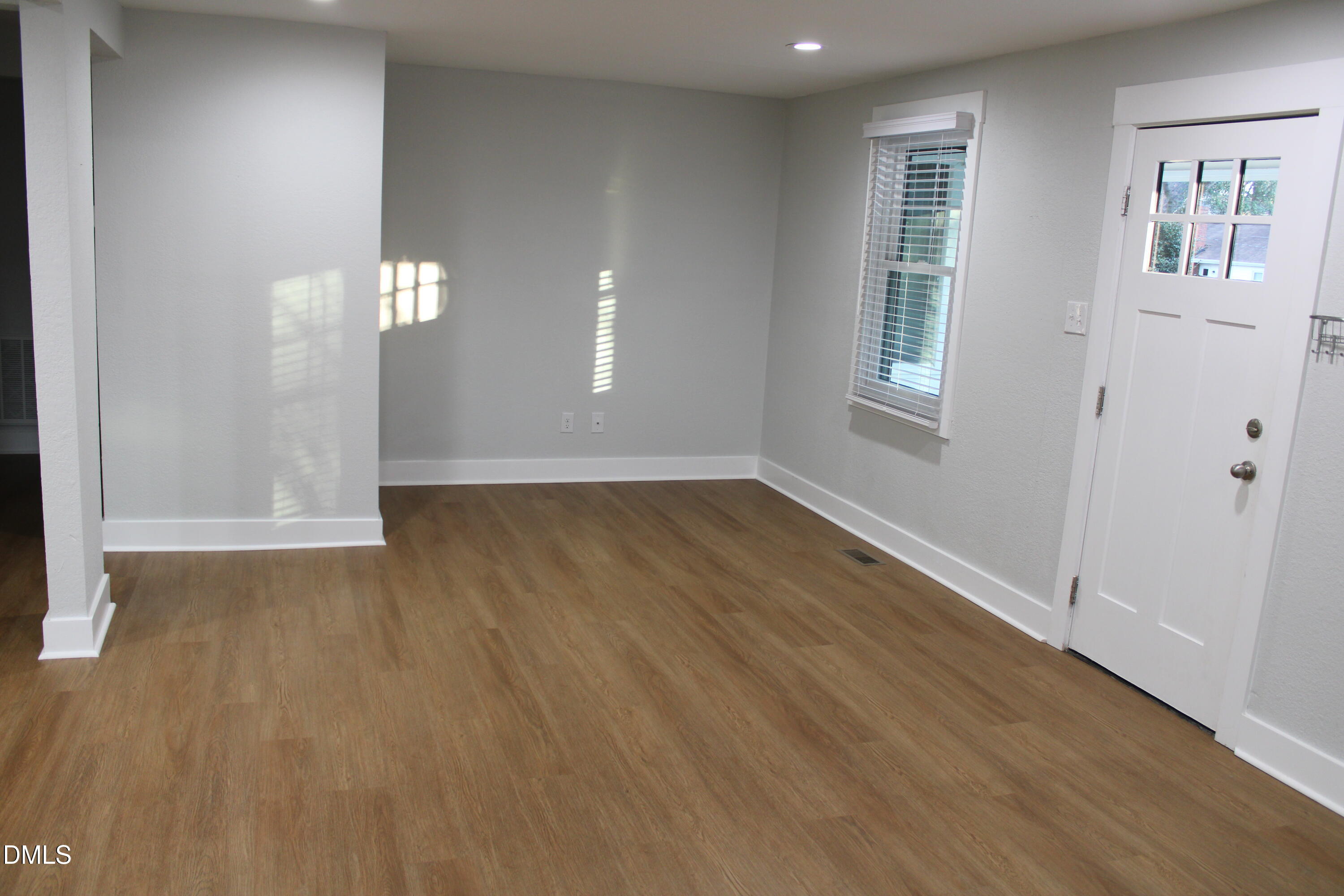 2812 Mayview Road Raleigh, NC 27607 - Photo 4 of 20 wooden floor in an empty room with a window