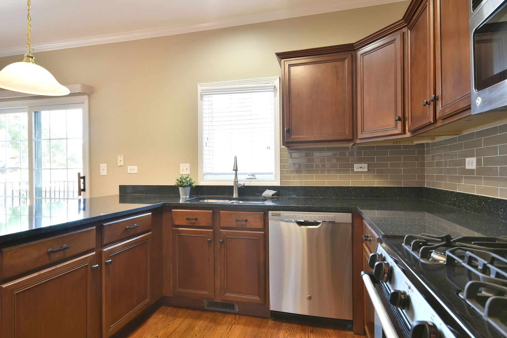 202 North Addison Avenue Elmhurst, IL 60126 - Photo 14 of 36 a kitchen with granite countertop a sink stove and cabinets