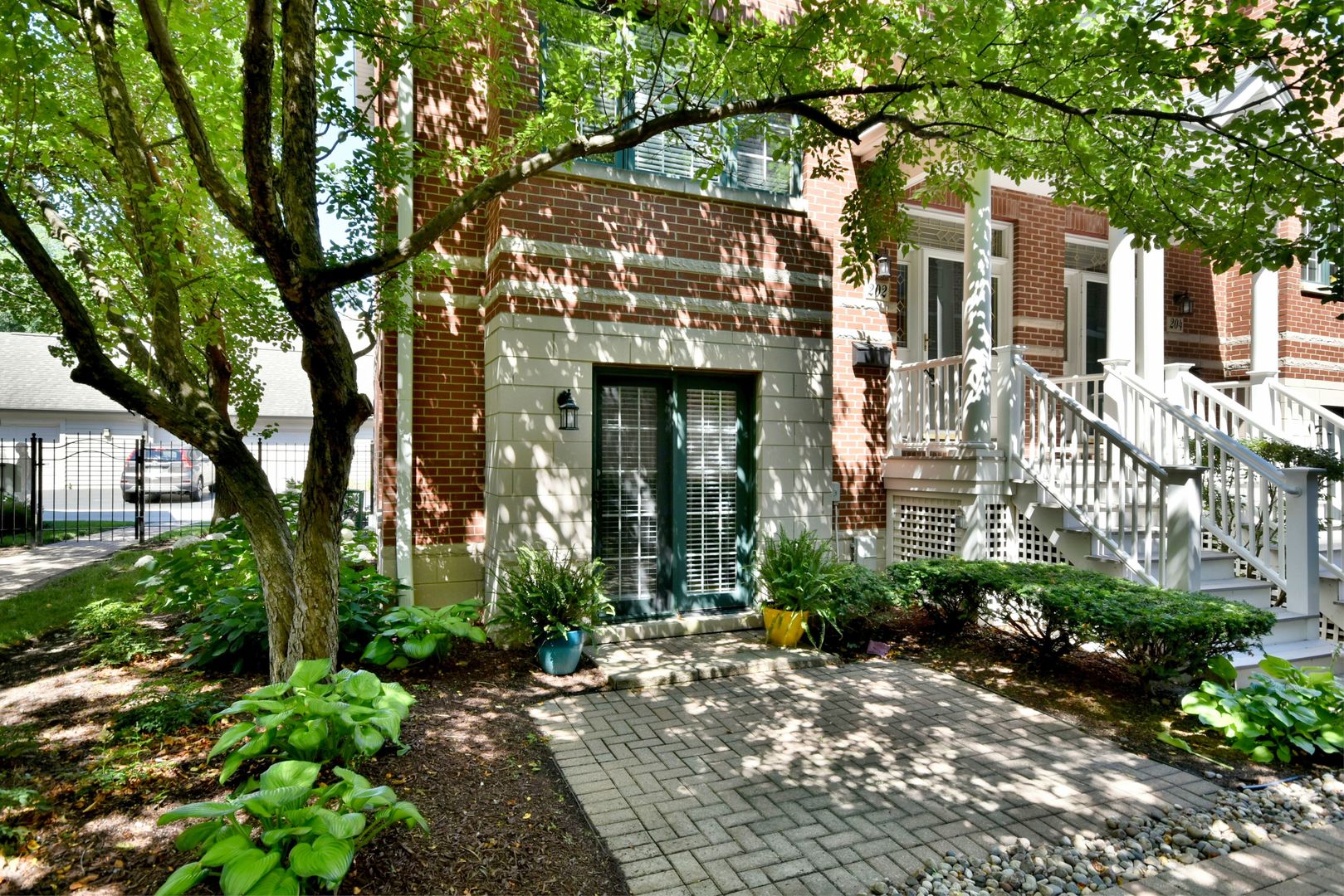 202 North Addison Avenue Elmhurst, IL 60126 - Photo 2 of 36 a view of a brick house with a large tree plants and large trees