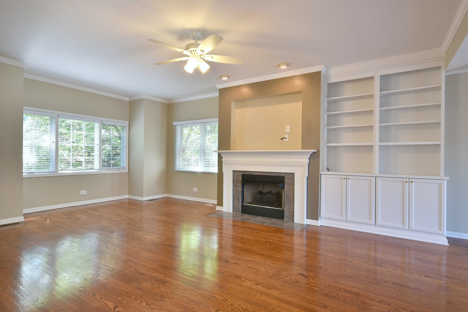 202 North Addison Avenue Elmhurst, IL 60126 - Photo 4 of 36 an empty room with windows fireplace and wooden floor