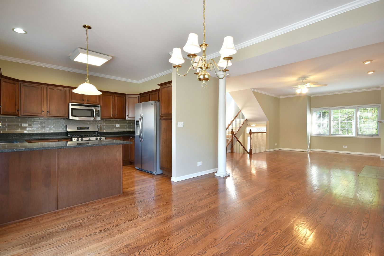 202 North Addison Avenue Elmhurst, IL 60126 - Photo 10 of 36 a kitchen with stainless steel appliances granite countertop a refrigerator a sink dishwasher a stove and a dining table with wooden floor