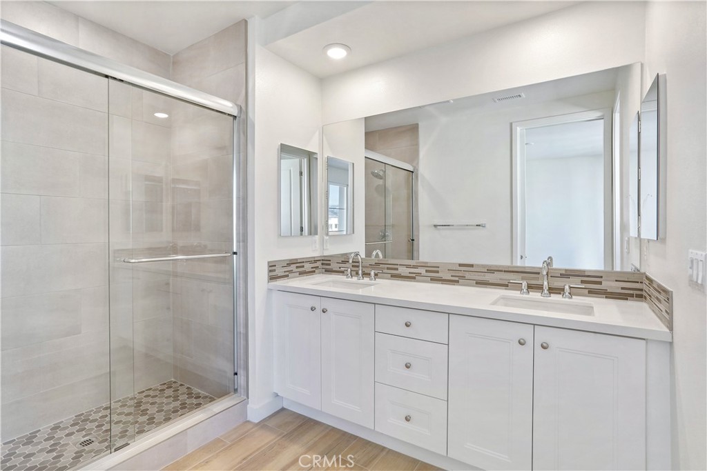 3185 Doheny Way Dana Point, CA 92629 - Photo 15 of 33 a bathroom with a granite countertop sink two mirror and shower