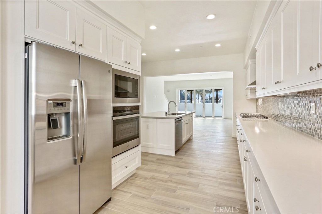 3185 Doheny Way Dana Point, CA 92629 - Photo 5 of 33 a large kitchen with a large counter top stainless steel appliances and cabinets