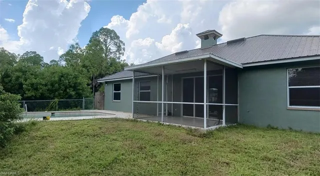 a house with lots of trees in the background