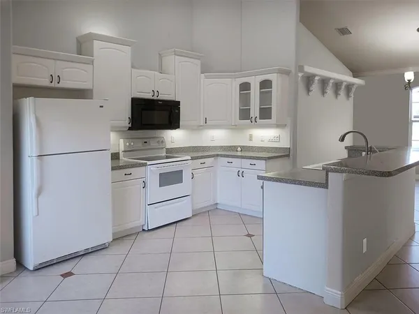 a kitchen with a sink stove and refrigerator