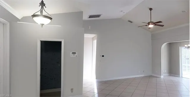 a view of a hallway with a chandelier fan
