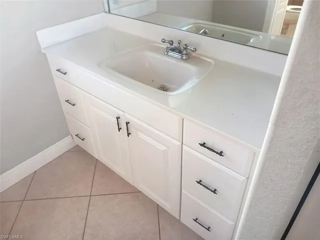 a bathroom with a sink and cabinets