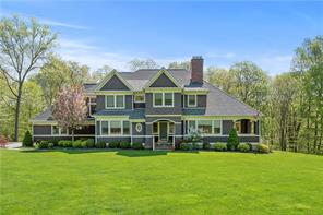 a front view of a house with a yard table and chairs