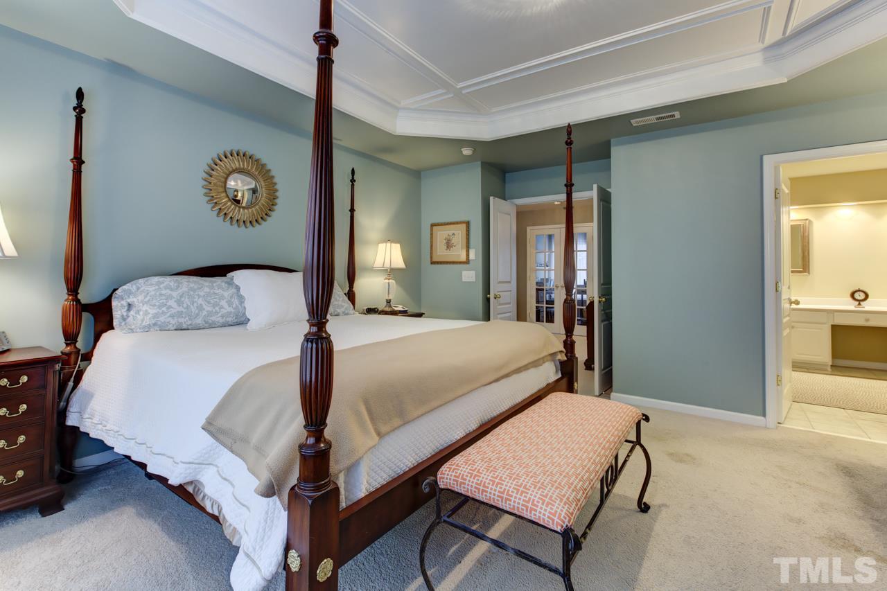 3743 Old Post Road Raleigh, NC 27612 - Photo 14 of 25 a bedroom with a bed and a lamp on a dresser