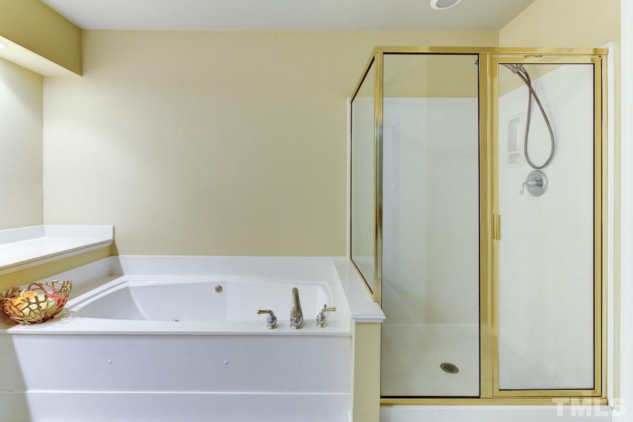 3743 Old Post Road Raleigh, NC 27612 - Photo 15 of 25 a bathroom with a bathtub and a shower
