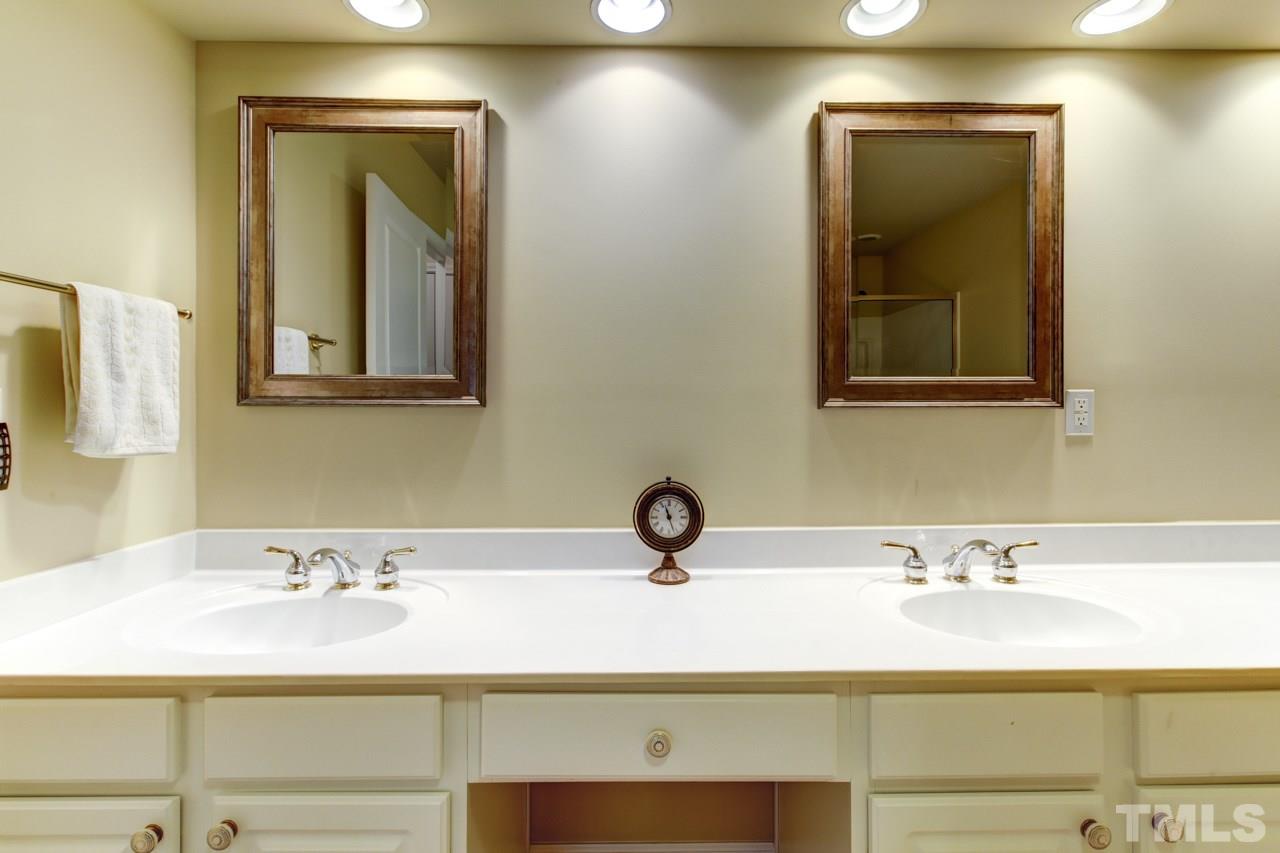 3743 Old Post Road Raleigh, NC 27612 - Photo 16 of 25 a bathroom with a sink and a mirror