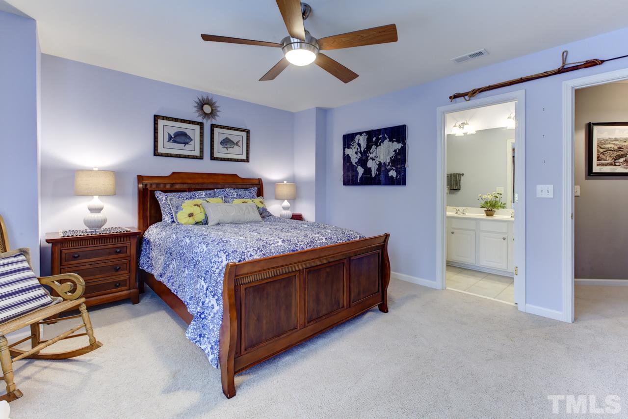 3743 Old Post Road Raleigh, NC 27612 - Photo 17 of 25 a bedroom with a bed and a lamp on a dresser